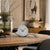 Table clock with round dial and curved metal base, anthracite