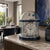 Table clock on shelf, glass dome with silver dial and blue border