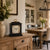 Black table clock on wooden sideboard with floral dial and gold-colored carrying handle