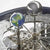 Clockwork with globe decor and gears under glass dome, silver metal parts