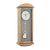 Wall clock with acorn-colored wooden case, blue-gray dial, and pendulum motif