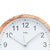Wall clock with wood-look frame and white dial, minute markers around the edge