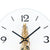 Wall clock with white dial, black hands, and gold mechanism in detail