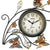 Runde Wanduhr mit schwarzem Rahmen, Ziffernblatt mit AMS und Metallranken