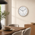 Wall clock with beige frame, white dial, and black hands and numbers