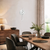 Wall clock on the wall with a white dial and a curved suspension