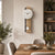 Wall clock with wooden frame and white pendulum on the wall