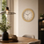 Wall clock on the wall, round beige wood design, white dial with hands