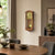 Wall pendulum clock on the wall, cherry wood casing with a golden pendulum ball