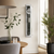Wall clock on the wall in a living room, transparent casing with visible clockwork