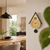 Cuckoo clock on the wall in the living room, teardrop-shaped, gold dial and black pendulum