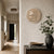 Round LED word clock in wood look on wall, luminous lettering