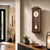 Walnut cased pendulum wall clock, dial with hands and pendulum at the bottom