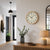 Wall clock on the wall: beige dial with black numbers and hands, wooden frame.