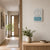 Wall clock on the wall with Ana-Digi display and analog hands, silver case