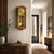 Pendulum wall clock on the wall, cherry wood colored case, gold dial