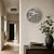 LED word clock on white wall: round metallic-colored dial with word scale