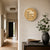 Round table clock with word display on wall, antique brass look dial and feet