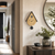 Cuckoo clock on the wall above a dresser, teardrop-shaped, gold dial and black pendulum