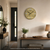 Wall clock on the wall with wood-look dial, metal numbers, and anthracite hands