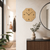 Wall clock: octagonal wooden case, beige dial with black numbers and hands.