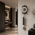 Metal wall clock on the wall with pendulum and chain weight
