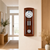 Wooden wall clock on the wall with a round dial, pendulum, and round gong in a wooden frame