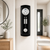 Wall clock on the wall: black case, white dial, and pendulum stripe