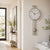 Hermle wall clock on the wall with pendulum, round dial with numbers