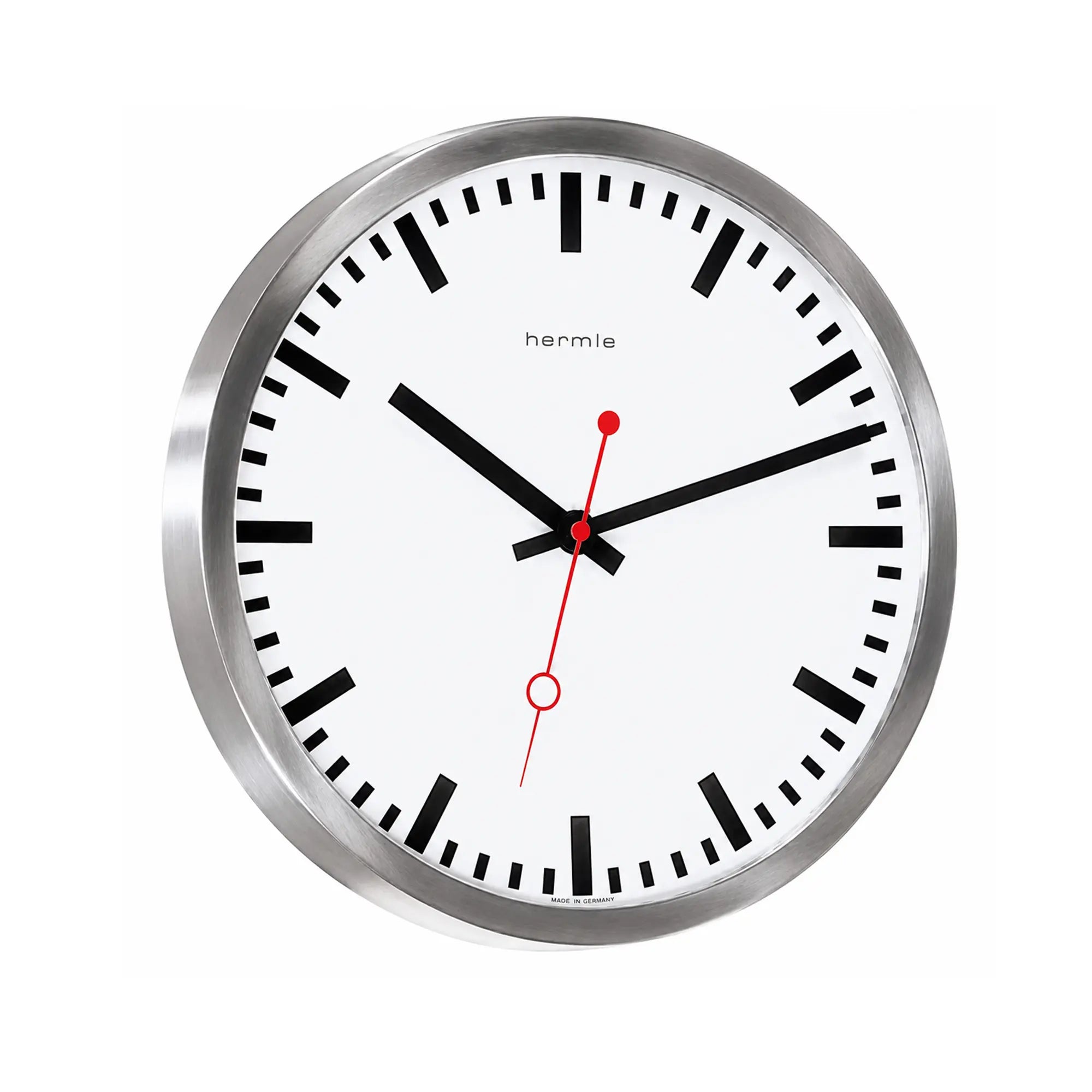 Close-up of a round wall clock: white dial, silver frame, black hands, red second hand