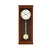Hermle Wanduhr aus Holz mit rundem Zifferblatt und Pendelgewicht in Glasscheibe