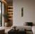 Wall clock on the wall with a narrow wooden frame, moss inlay, and white ring