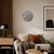 Round LED word clock on the wall with metallic-colored round dial and word display