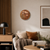 LED word clock with copper-colored round dial, on the wall, with power cable