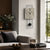 Wall clock with gray concrete look, black pendulum and black hands, and Roman numerals