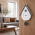AMS wall clock on wood front, light gray housing, black frame, white dial