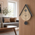 Cuckoo clock wall clock in wood look with cuckoo window, hands, and black round weight