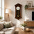 Dark wood wall clock with white dial and gold-colored pendulum ball