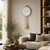 Wall clock with round dial and pendulum: ball weight, three vertical rods