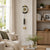 Wall clock on the wall with a gold dial and black pendulum