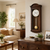Wooden wall clock made of wood with a round dial and gold pendulum rod