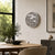 Round LED word clock on the wall with metallic dial and word display
