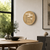 Clock-like table clock on a light wall: round dial in antique brass look