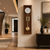 Wooden wall clock made of brown wood with a white dial, gold-colored gong bars, and pendulum
