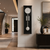 Wall clock with black housing, white dial, and silver ball pendulum