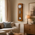 Wooden wall clock with round dial, glass window, and metal pendulum