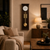 Walnut wall clock with brass pendulum and round weight, white dial