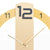 Close-up of wall clock with 3D number 12 on beige dial and hands