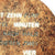 Close-up of a copper-colored round dial, text "Minuten" and "Nach halb"