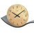 AMS table clock in detail: beige dial, black hands, and gray base